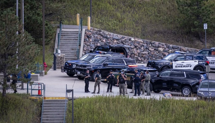 Law enforcement officers on the scene at Evergreen High School on September 10, 2025. — AFP