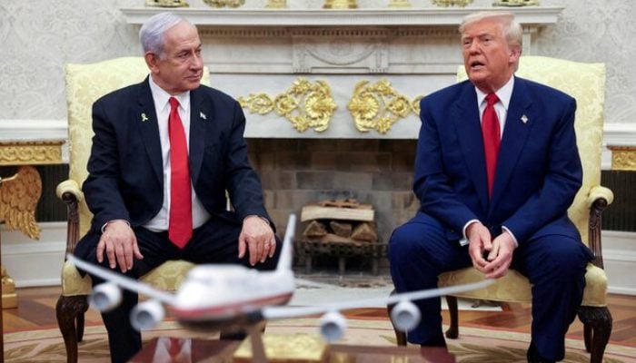 US President Donald Trump talks to Israeli Prime Minister Benjamin Netanyahu during a meeting where Trump announced nuclear talks with Iran, Washington, US, April 7, 2025. — Reuters