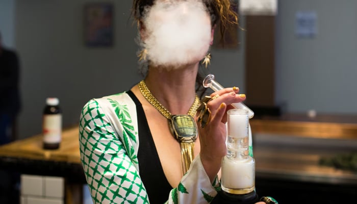A woman uses a full spectrum oil vaporizer at a vape lounge in Oakland, California, US April 20, 2018. — Reuters