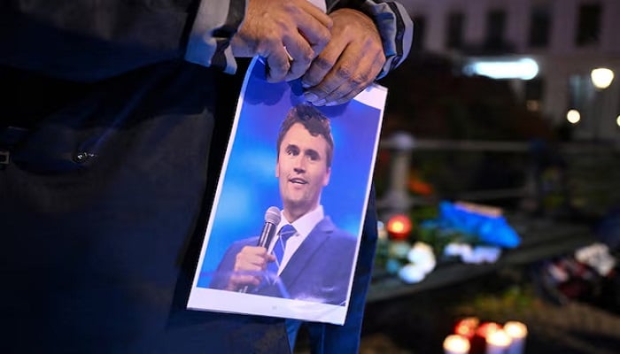 A man holds a picture of Charlie Kirk during a vigil under the line In Memory of Charlie Kirk, for freedom, patriotism and justice in front of the Embassy of the United States after US right-wing activist, commentator, Charlie Kirk, an ally of US President Donald Trump, was shot dead during an event at Utah Valley University, Orem, US, in Berlin, Germany September 11, 2025.— Reuters