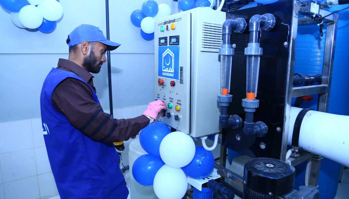 This image shows a man filling water from a filtration plant. — Al-Khidmat Foundation/Website