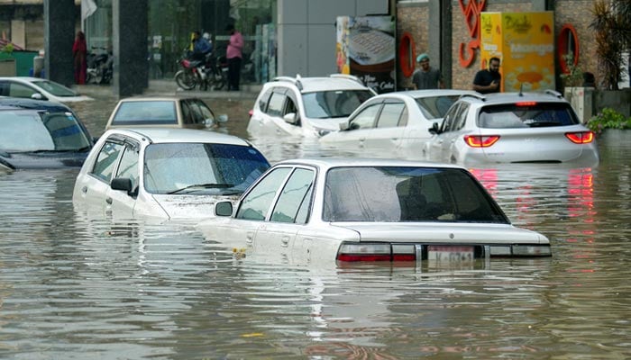 Partially submerged vehicles move, as some are parked, after the monsoon rain in Karachi, Pakistan, August 19, 2025. — REuters