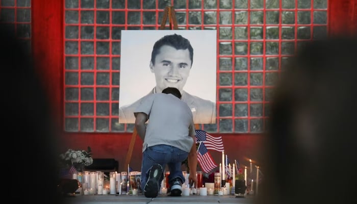 A man places a candle during a vigil at Orem City Center Park, after US right-wing activist and commentator, Charlie Kirk, an ally of US President Donald Trump, was fatally shot during an event at Utah Valley University, in Orem, Utah, US, September 11, 2025. — Reuters