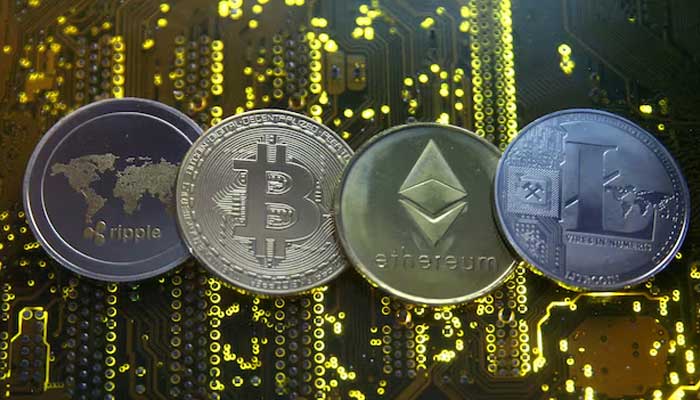 Representations of the Ripple, Bitcoin, Etherum and Litecoin virtual currencies are seen on a PC motherboard in this illustration picture. — Reuters/File