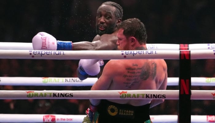 Terence Crawford (behind) throws a punch at Canelo Alvarez during their blockbuster bout on Saturday in Las Vegas, September 13, 2025. — Reuters