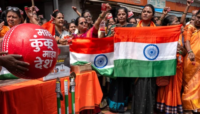 Activists of the political party Shiv Sena hold national flags as they take part in a protest in Mumbai against the match. — AFP/File