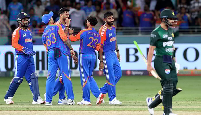 Indias Kuldeep Yadav celebrates with teammates after taking the wicket of Pakistans Hasan Nawaz, caught out by Indias Axar Patel. — Reuters