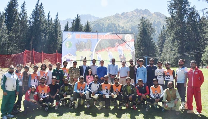 Participants of the 2nd Gilgit-Baltistan Grass Ski Championship pose for a group photo in Naltar Valley. — Winter Sports Federation
