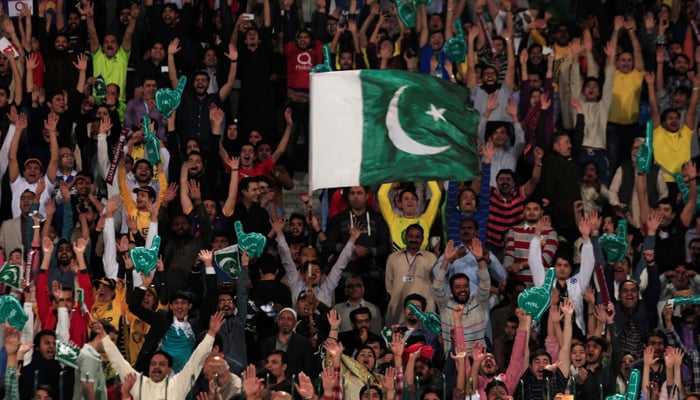 Pakistani spectators cheer during a match at the Gaddafi Cricket Stadium in Lahore. — Reuters