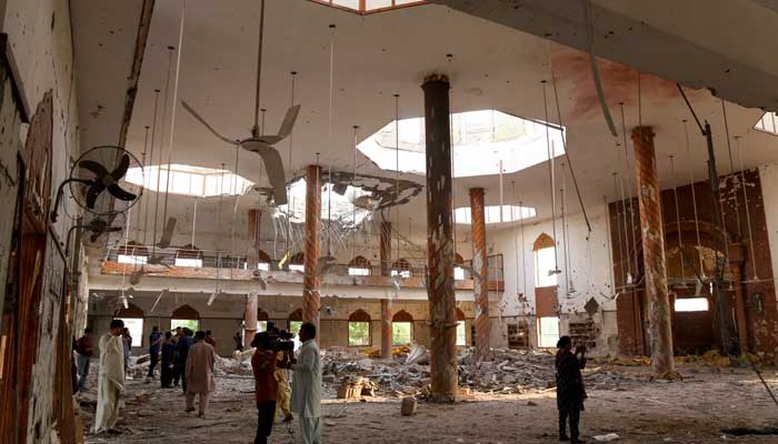 Members of the media film the inside of a building after it was hit by an Indian strike in Bahawalpur on May 7, 2025. — Reuters