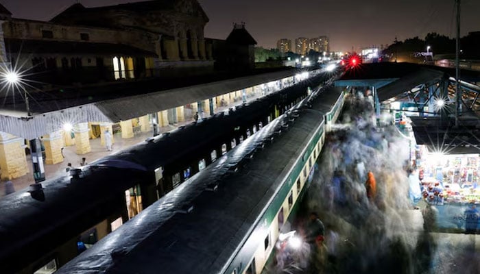 Passengers get on board a train at the Cantonment railway station in Karachi, on April 8, 2024.— Reuters