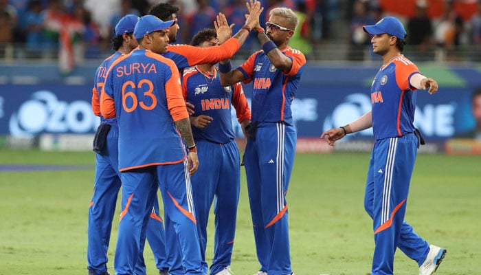 Indian players celebrate the wicket of Pakistans Sahibzada Farhan at the Dubai International Cricket Stadium on September 14, 2025. — Reuters