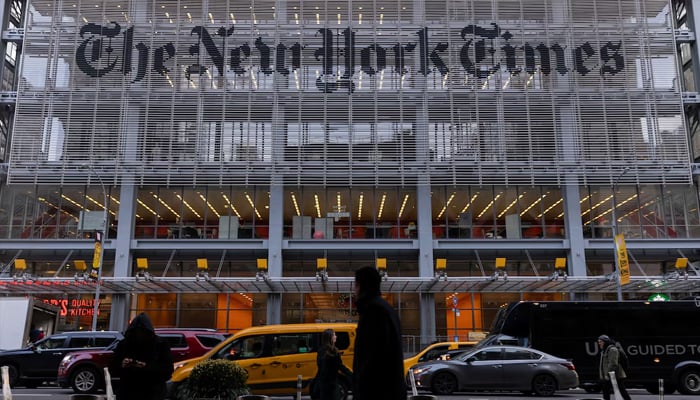 Pedestrians walk by the New York Times building in Manhattan, New York, U.S., December 8, 2022. — Reuters