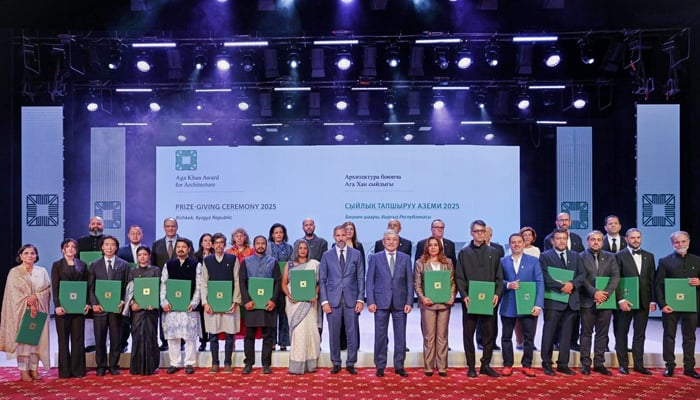 Winners of the Aga Khan Award for Architecture pose at the prize-giving ceremony at the Kyrgyz National Philharmonic Hall.
