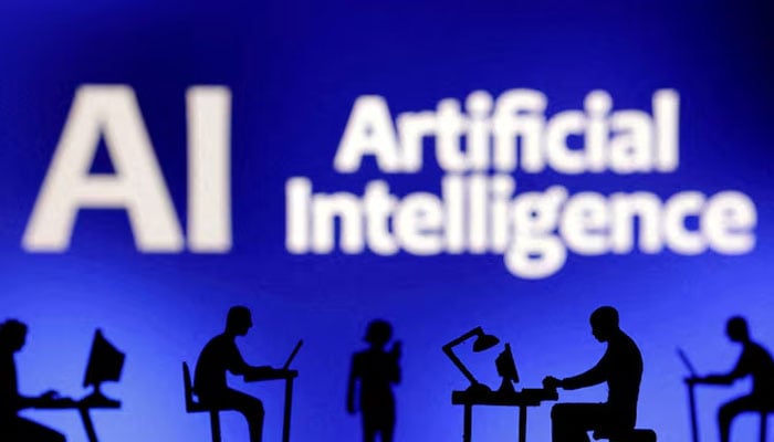 Figurines with computers and smartphones are seen in front of the words Artificial Intelligence AI in this illustration created February 19, 2024.—Reuters