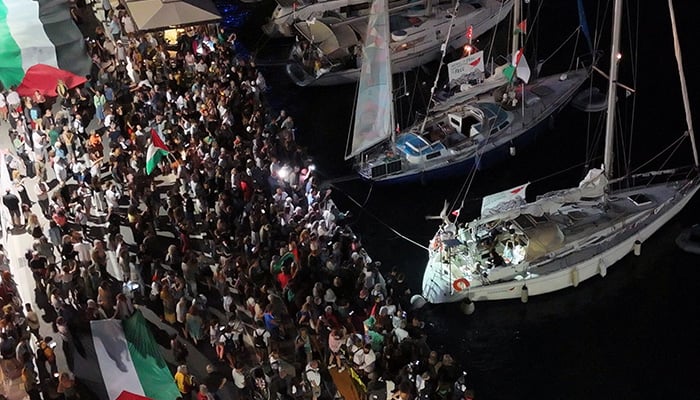 A screenshot from a drone video shows people gathering at the port of Ermoupolis during the departure of two sailing boats, Electra and Oxygen, part of the Global Sumud Flotilla aiming to reach Gaza and break Israels naval blockade, on Syros island, Greece, September 14, 2025. — Reuters