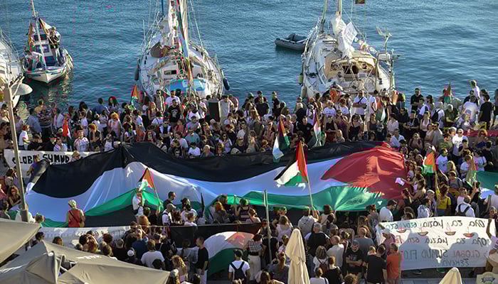 A Palestinian flag is seen as people gather at the port of Ermoupolis before the departure of two sailing boats, Electra and Oxygen, part of the Global Sumud Flotilla aiming to reach Gaza and break Israels naval blockade, on Syros island, Greece, September 14, 2025. — Reuters