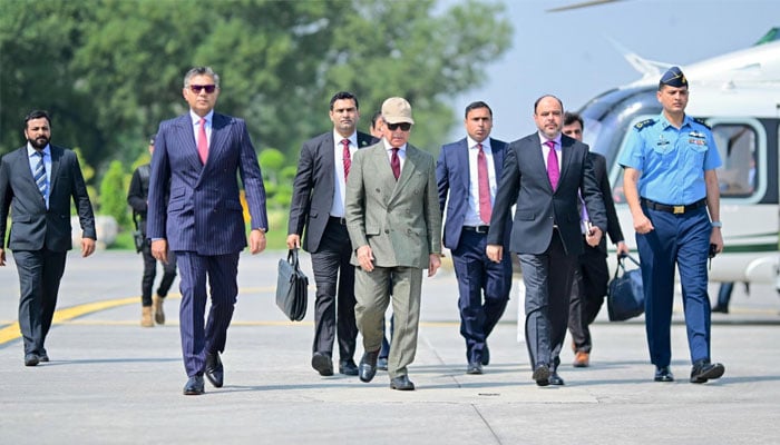 Prime Minister Shehbaz Sharif walks towards his jet ahead of his visit to Saudi Arabia on September 17, 2025. — PID