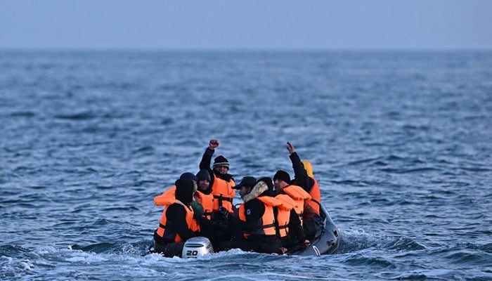 Migrants travel in an inflatable boat across the English Channel, bound for Dover on the south coast of England. — AFP/File