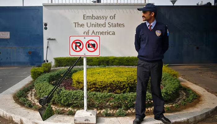 A private security guard stands outside the US embassy in New Delhi December 18, 2013.— Reuters