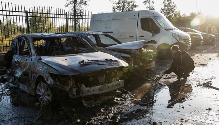 A police officer works near damaged vehicles at the site of a residential building damaged during a Russian drone and missile strike, amid Russias attack on Ukraine, in the outskirts of Kyiv, Ukraine, September 20, 2025. — Reuters