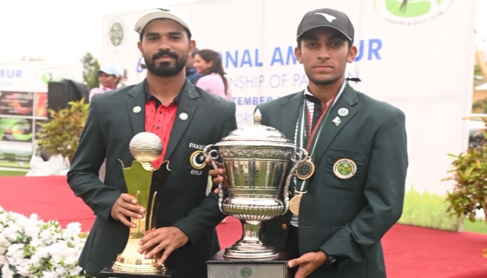 Pakistani golfers Saad Habib Malik and Nouman Ilyas pose with winning trophies in an undated photo — Reporter