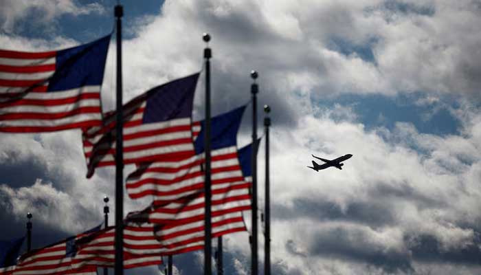 A Boeing 737-823 operated by American Airlines takes off from the Reagan National Airport as US  flags flutter in Washington, US, November 23, 2024.  – Reuters