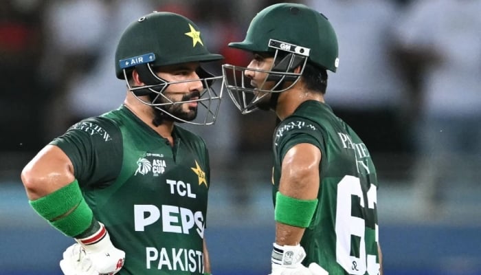 Pakistans Sahibzada Farhan and Saim Ayub chat during the Asia Cup 2025s Super Fours match against India at Dubai International Cricket Stadium, Dubai, UAE, on September 21, 2025. — AFP