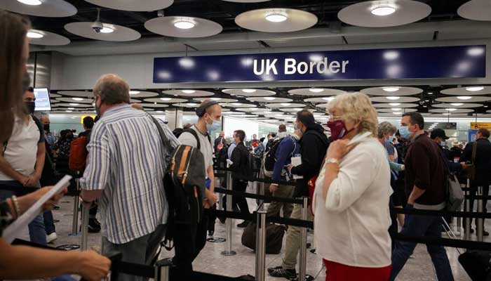 Arriving passengers queue at UK Border Control at the Terminal 5 at Heathrow Airport in London, Britain June 29, 2021. — Reuters