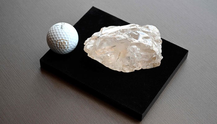 A golf ball is placed next to the Motswedi a 2,488-carat rough diamond, the second largest in the world, at the HB Antwerp diamond company headquarters in Antwerp, on September 22, 2025.— AFP