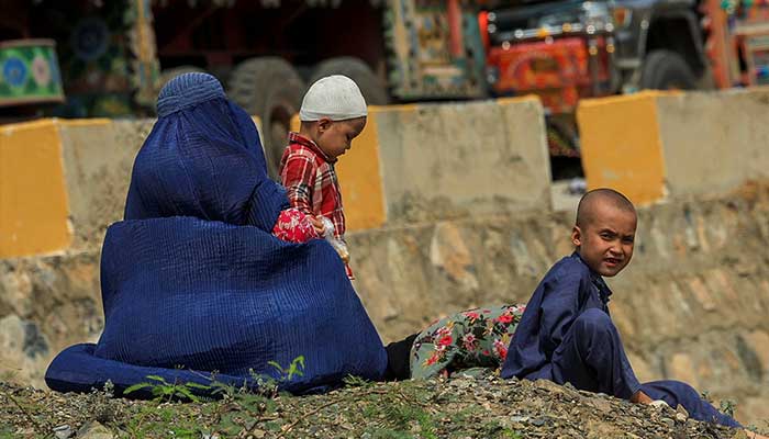 An Afghan family rests near Torkham border crossing between Pakistan and Afghanistan, September 1, 2025. — Reuters