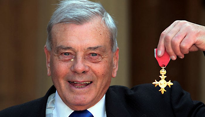 Former cricket umpire Harold Dickie Bird poses with his Officer of the Most Excellent Order of the British Empire (OBE) award after being knighted by Britains Prince Charles at Buckingham Palace in London May 15, 2012. — Reuters