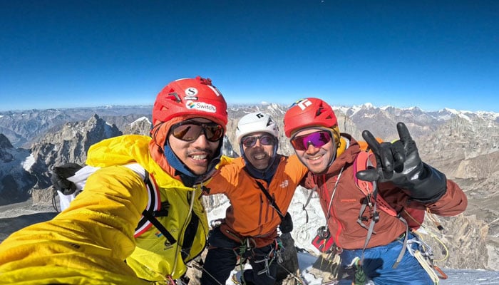 The group posing after summitting the 6080m high peak.— Reporter