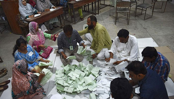 ECP staff count votes in Karachi. — AFP/File