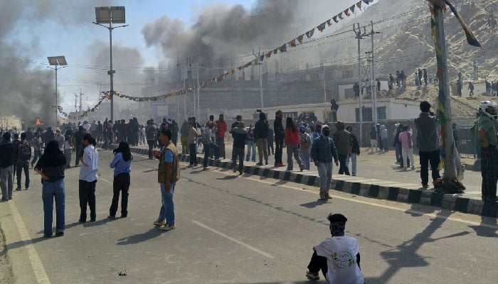 Smoke rises from a police vehicle that was torched by the demonstrators near the Bharatiya Janata Party (BJP) office in Leh on September 24, 2025. — AFP