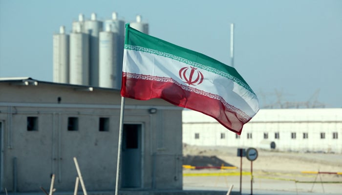 Iranian flag flutters in front of a nuclear site in Iran. — AFP