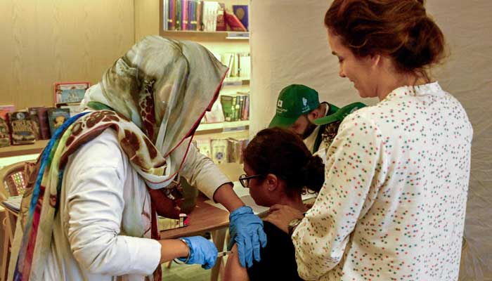 A health worker  administers HPV vaccine to a girl in Karachi on September 24, 2025, 2025. — AFP