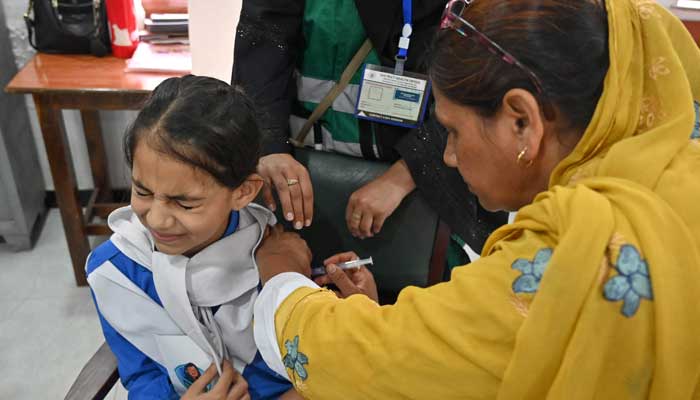 A health worker administers HPV vaccine to a school student in Islamabad on September 24, 2025. — AFP