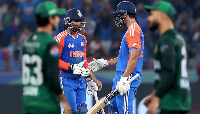 Indias Tilak Varma celebrates after reaching his half century with Shivam Dube. — Reuters