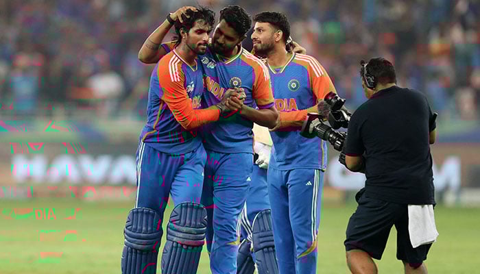 Indias Tilak Varma celebrates with Varun Chakravarthy after winning the Asia Cup. — Reuters