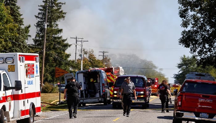[2/3] Smoke rises as emergency personnel work at the scene of a shooting which took place at the Church of Jesus Christ of Latter-day Saints, according to police, in Grand Blanc, Michigan, US, September 28, 2025.—Reuters