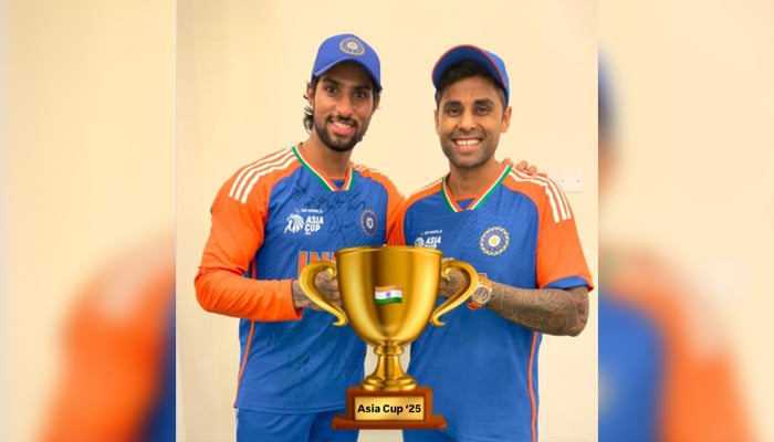 Indian skipper Suryakumar Yadav and Tilak Verma seen pose for a picture including a sticker of a trophy to celebrate Asia Cup 2025 win. — Instagram@surya_14kumar