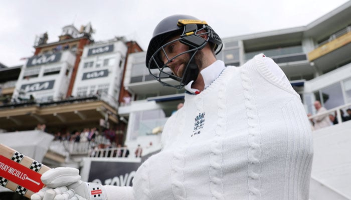Chris Woakes walks out to bat with his injured arm in fifth test match of International Test Match Series India at Kia Oval, London, Britain on August 4, 2025. — Reuters