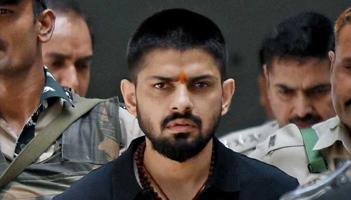 Police escort Lawrence Bishnoi at a court in New Delhi, India, on 18 April 2023. —Reuters