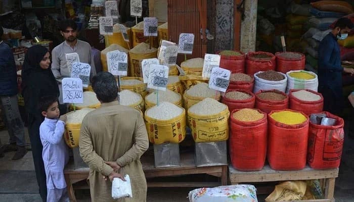 Representational image of people buy pulses and grains at a wholesale market. — AFP/File
