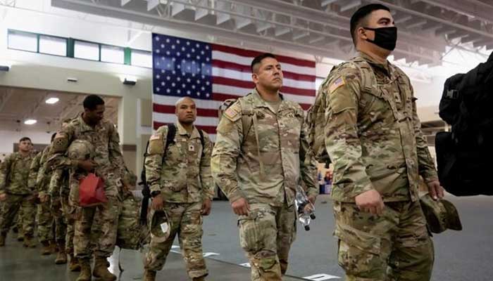 US Army soldiers from B Company wait in a staging area before boarding a transport plane bound for Europe on a deployment launched in response to the invasion of Ukraine by Russia, at Hunter Army Airfield in Savannah, Georgia, US, March 11, 2022. — Reuters