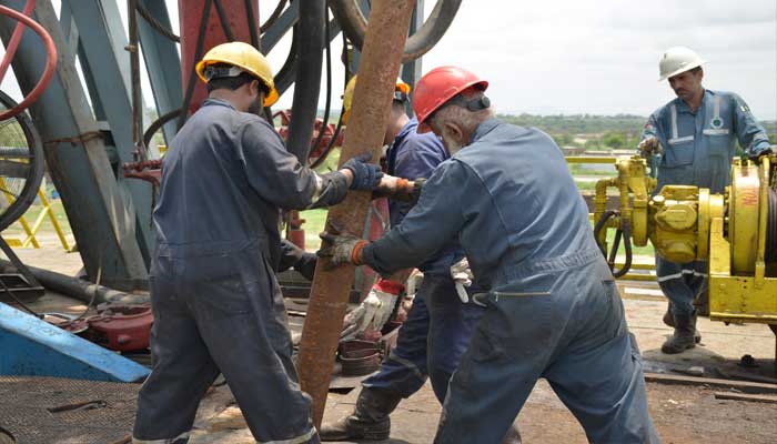 OGDCL workers can be seen working in a gas field in this undated image. — X@ogdclofficial