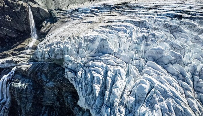A drone view shows water from melting ice running down the side of the Turtmann glacier on a warm summer day, amid climate change, in Turtmann, Switzerland, September 3, 2025. — Reuters