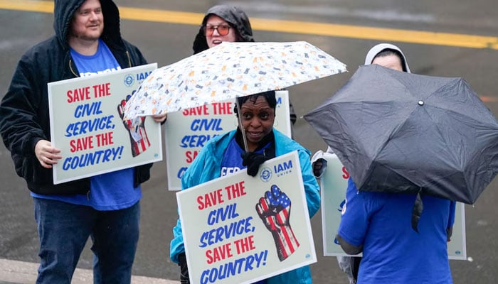 Labour union members hold placards on the day of a rally in support of federal workers during a rush hour protest outside the LEnfant Plaza Metro Station in Washington, DC, US, March 24, 2025. — Reuters