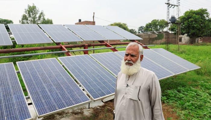 Mohammad Naseem, 65, a farmer, stands beside his solar panels, installed to run a tube well, the motorised pump that tap groundwater, amid a rice field, in Muridke, Sheikhupura District in Punjab, August 12, 2025. — Reuters